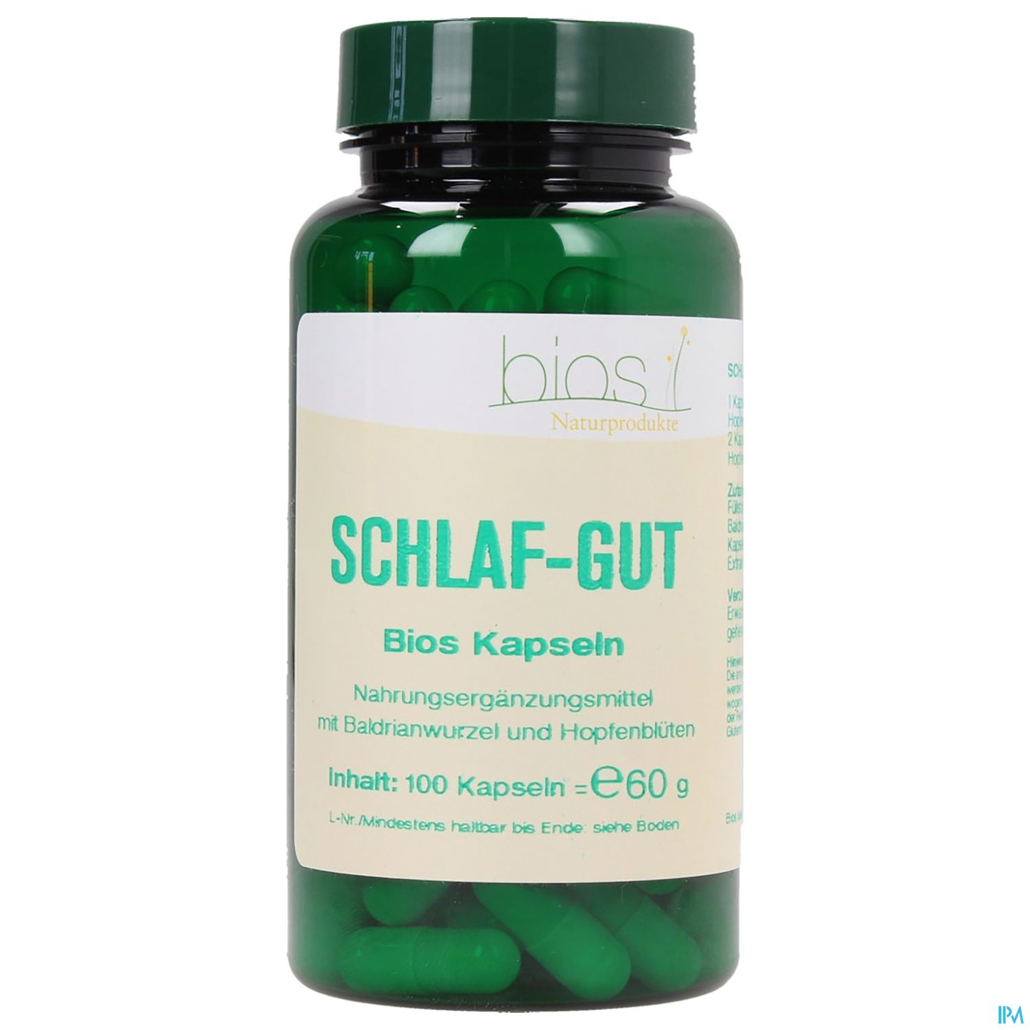 Grüne Kapseln in einem transparenten Behälter mit der Aufschrift "SCHLAF-GUT", einem Nahrungsergänzungsmittel mit Badrianwurzel und Hopfenblüten, Inhalt: 100 Kapseln.