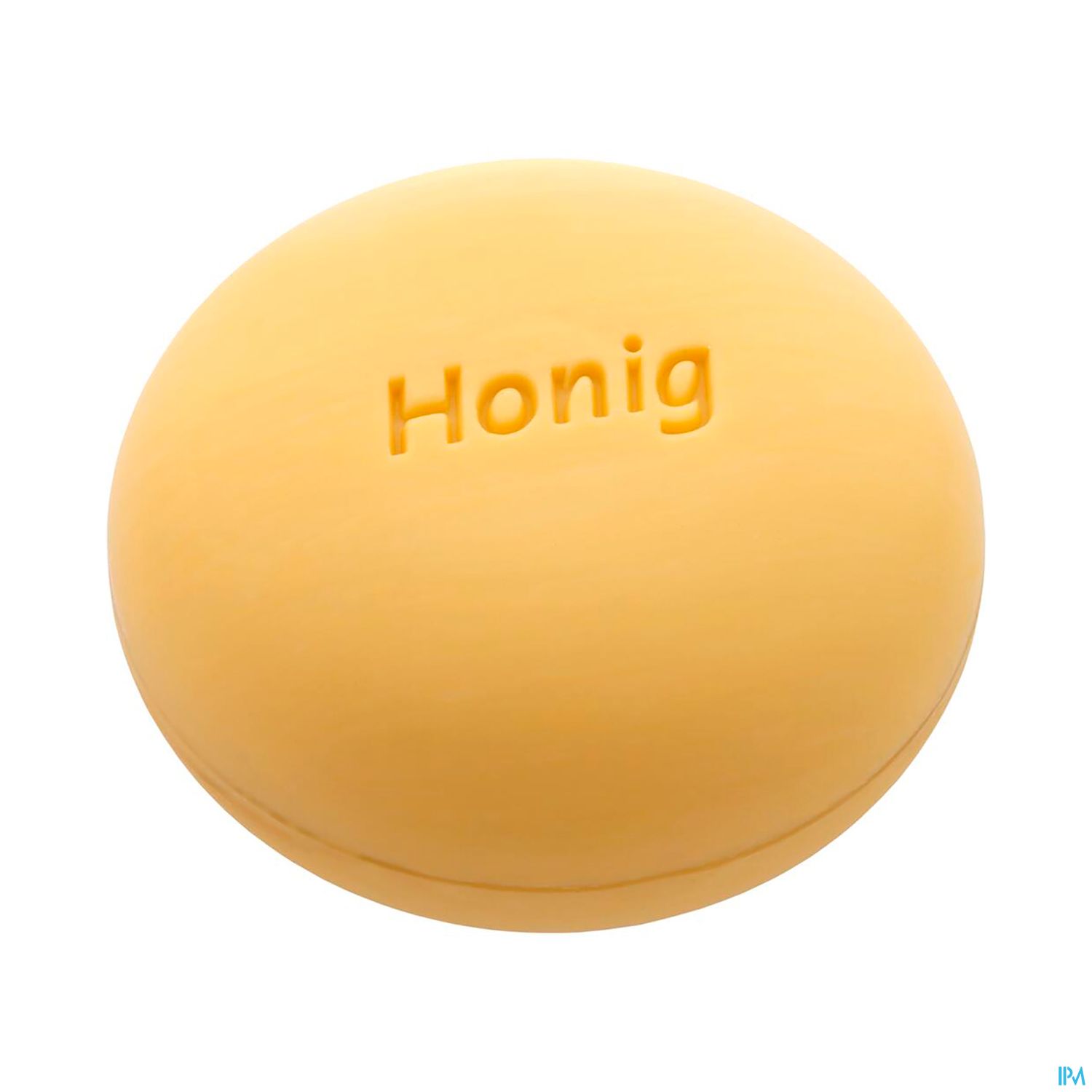 Runde Seife mit dem eingeprägten Wort "Honig" in gelber Farbe.