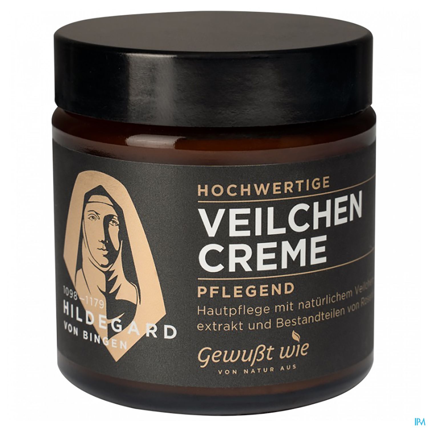 Braune cremefarbene Dose mit schwarzem Deckel und Etikett, beschriftet mit "Hochwertige Veilchen Creme" und "Pflegend". Das Etikett zeigt ein Abbild von Hildegard von Bingen.