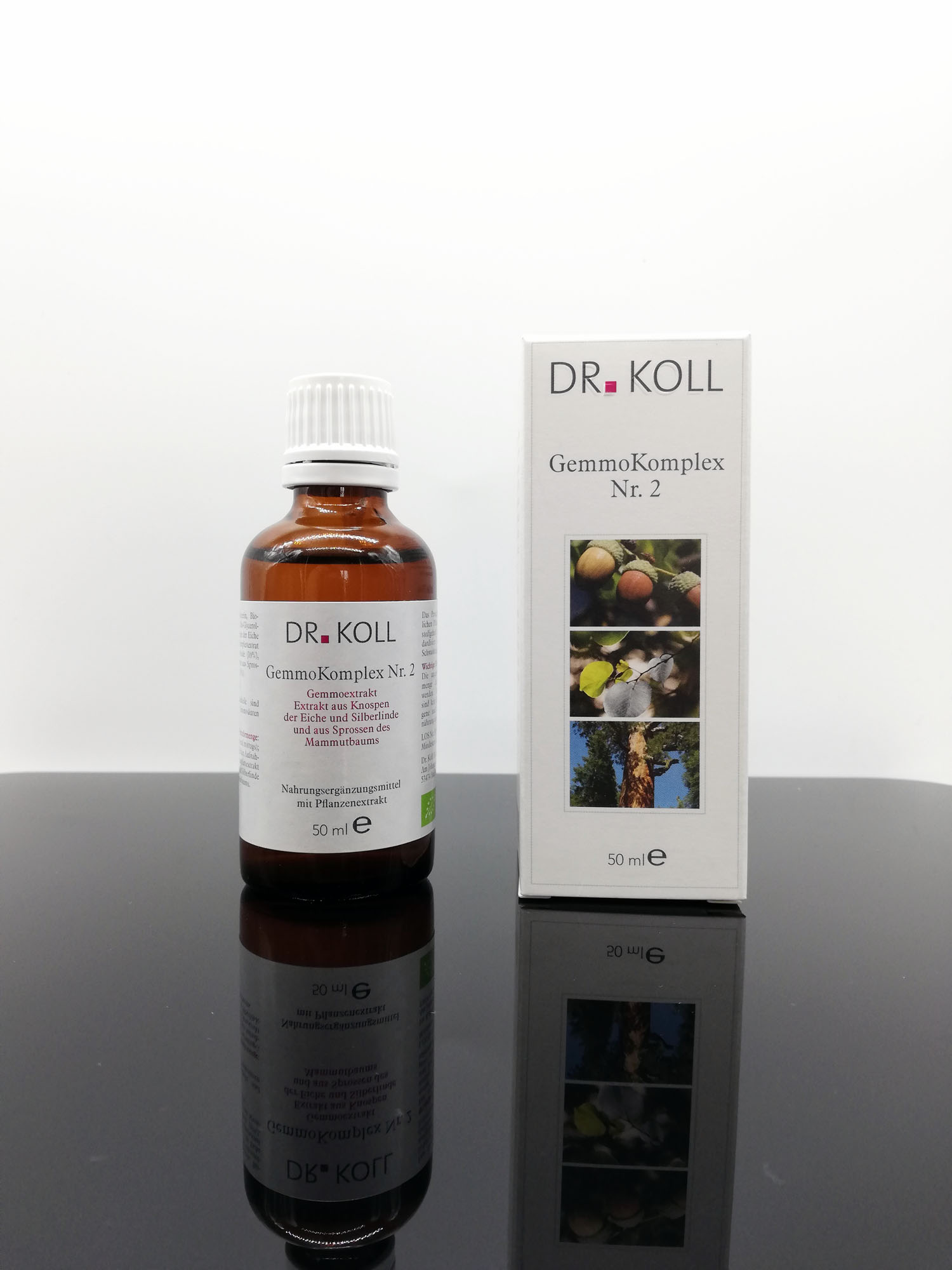 Flasche mit "Dr. Koll GemmoKomplex Nr. 2" und Verpackung auf schwarzem Hintergrund.